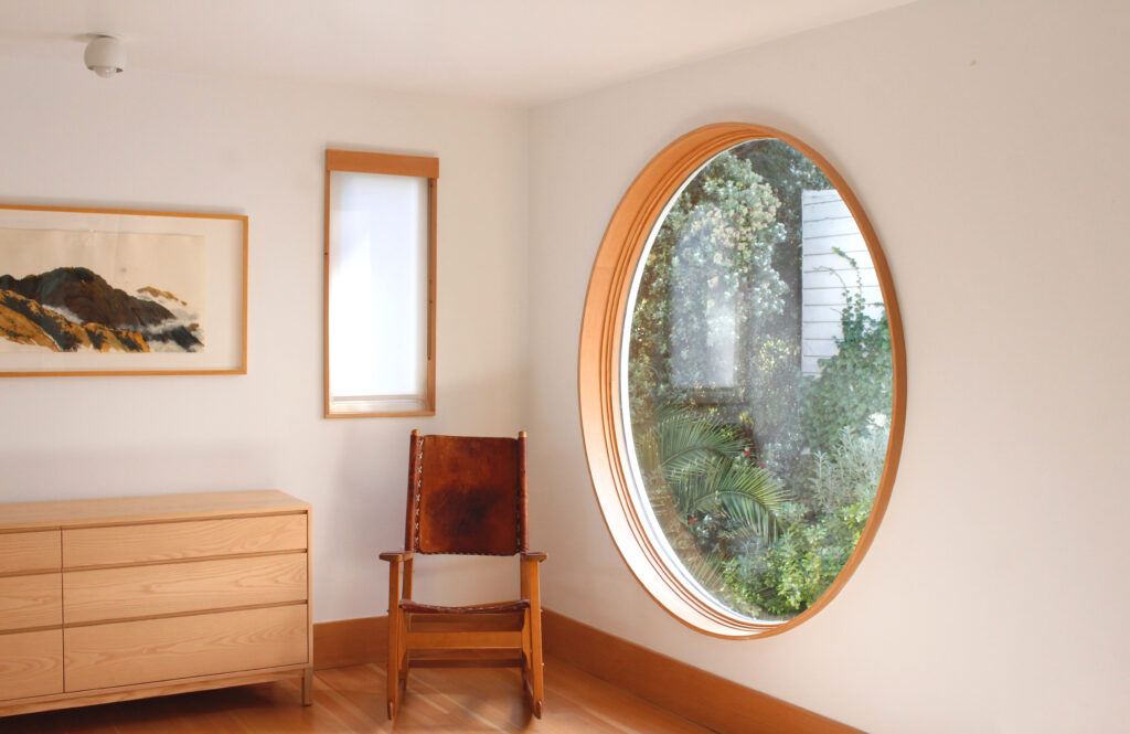 circular window and dresser in master bed // Carriage House by Sky Lanigan with Medium Plenty